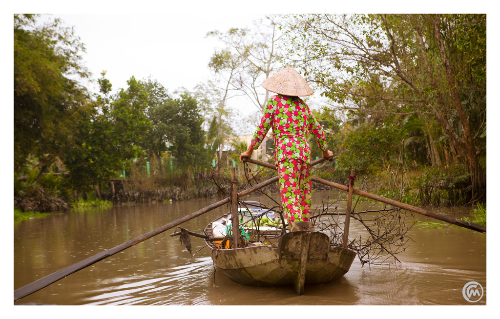 Woman on long tail boat, Mekong Delta, Vietnam
